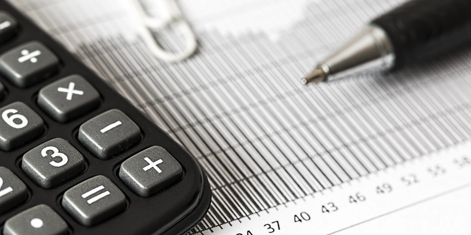 Calculator and pen on top of form