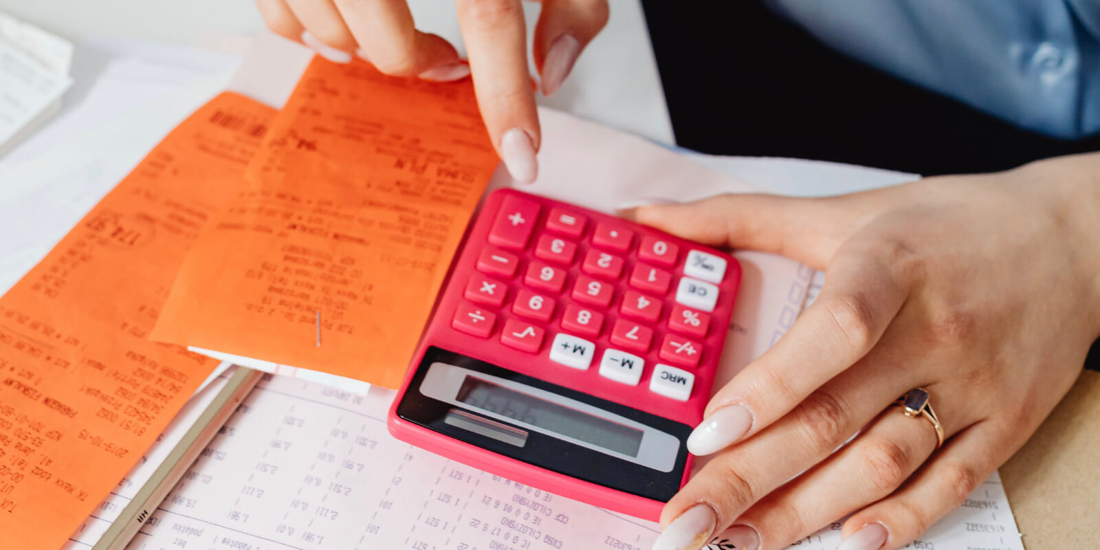 person typing figures into calculator